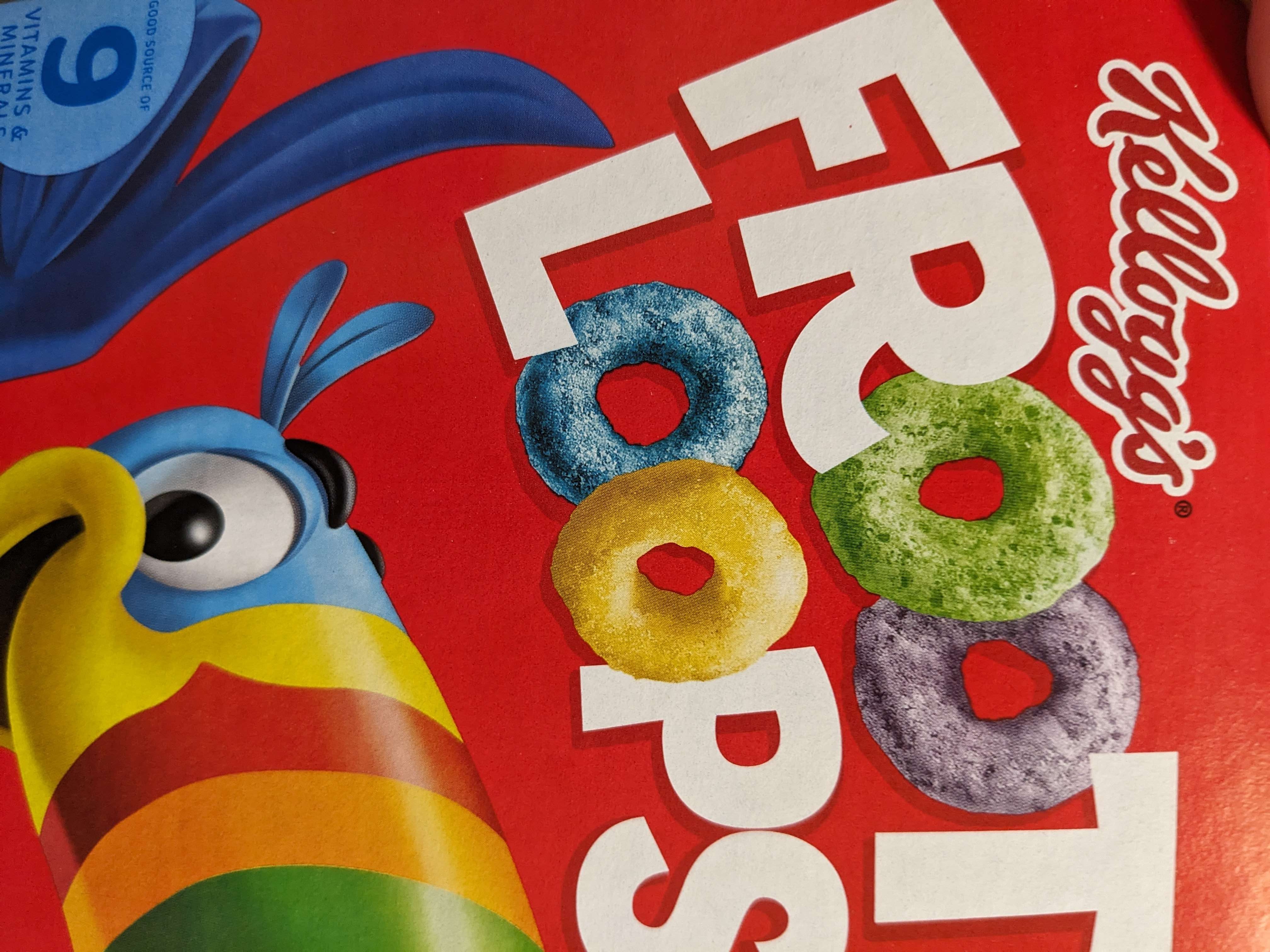 Froot Loops box rotated 90° clockwise, with the O's in the words "Froot Loops" replaced with pictures of actual froot loops. From the top left in clockwise order, the colours of the froot loops are blue, green, purple, and yellow.