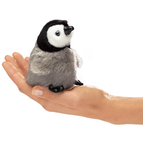 A penguin being held by a hand