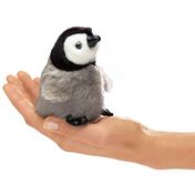 A penguin being held by a hand